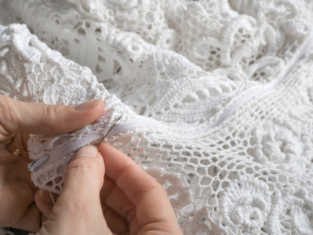 sewing wedding dresses from irish lace. close up.